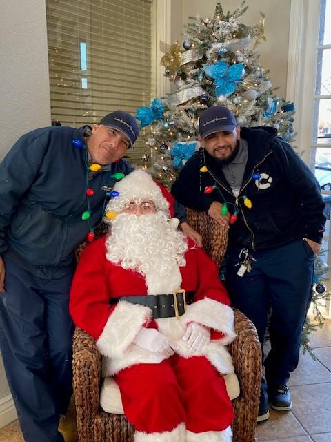 Lewis employees with Santa